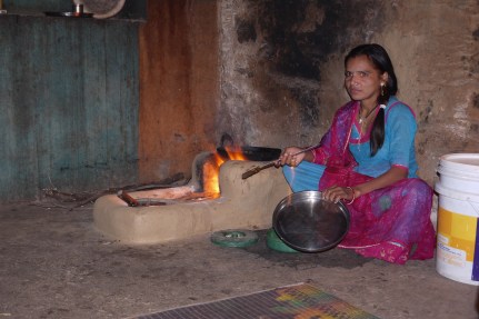 Making  the roti for our dinner on a clay stove at the village